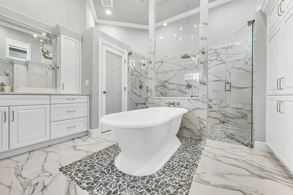Master bathroom remodel with marble tile shower walls and mosaic tile floor in Bonita Springs FL